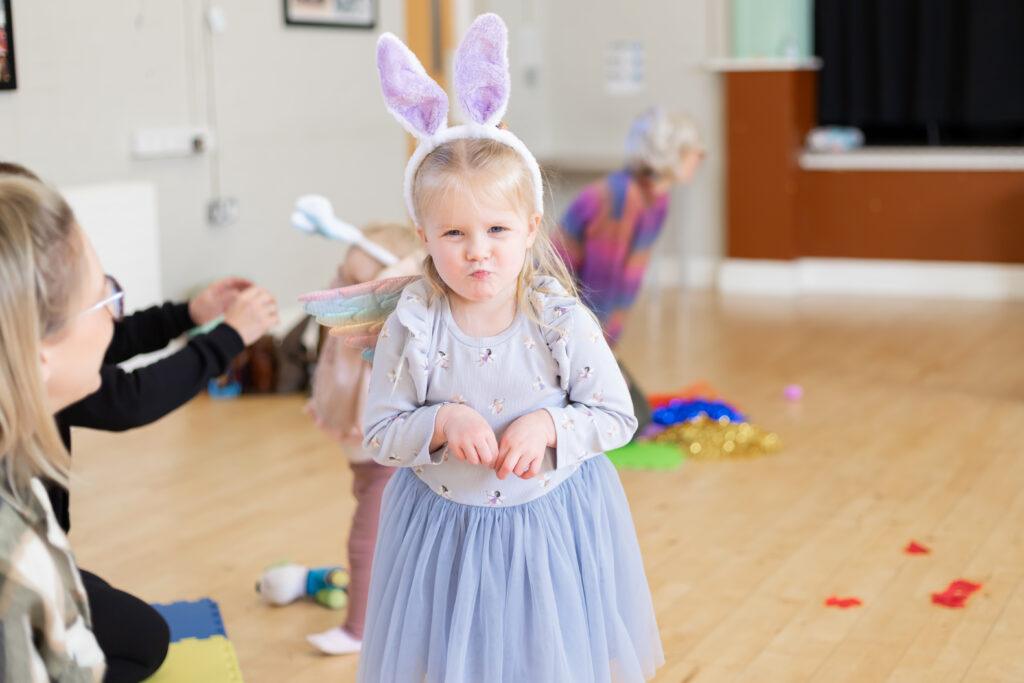 child dressed up as a bunny in a storytelling class
